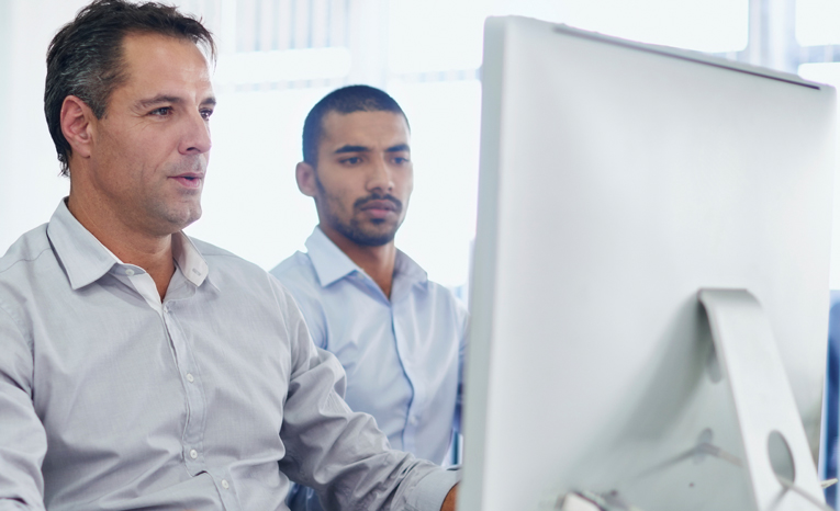 Man looking at screen and smiling