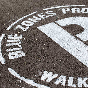 Road surface marking with the text "Blue Zones Project"