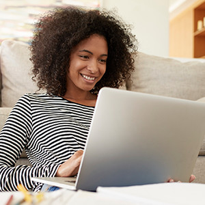 Woman smiling at her laptop